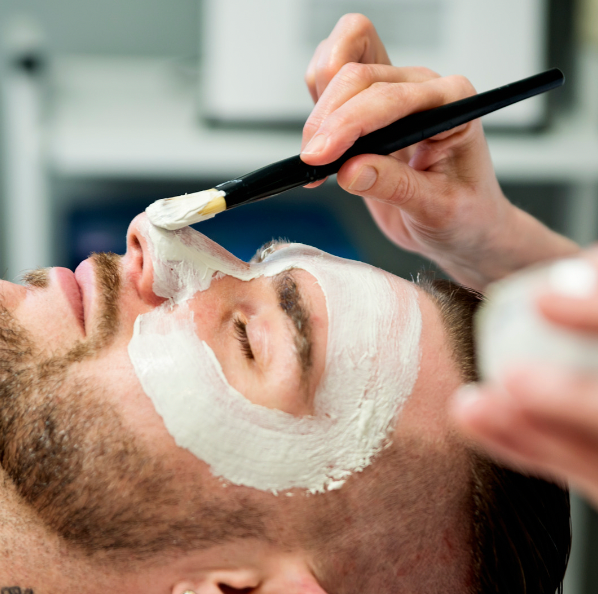 Indulge in our luxurious facial treatment with a Presidential facial featuring deep cleansing, massage, and hydration. An aesthetician applying a soothing mask on a client's face, showcasing the pampering experience.